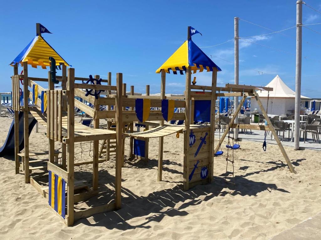 a wooden playground on the beach at Cosmopolitan Golf & Beach Resort in Tirrenia