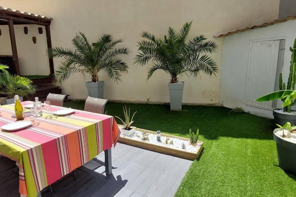 une terrasse avec une table et des plantes en pot dans l'établissement Appartement avec terrasse en plein centre-ville, à Marseille