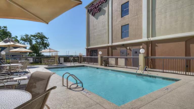 a swimming pool in front of a hotel at Hampton Inn Georgetown-Marina in Georgetown