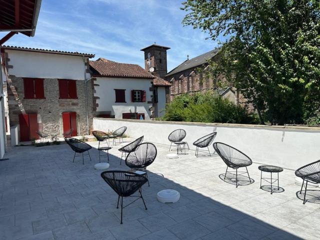 a group of chairs and tables on a patio at Maison LAURENTZENIA in Saint-Jean-Pied-de-Port