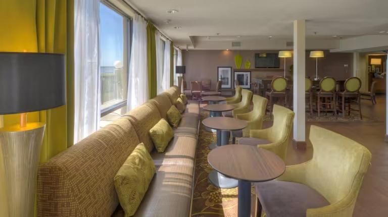 a lobby with couches and tables in a room at Hampton Inn Georgetown-Marina in Georgetown