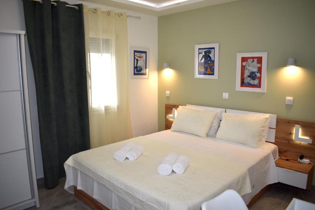 Postel nebo postele na pokoji v ubytování Zoé Suites
