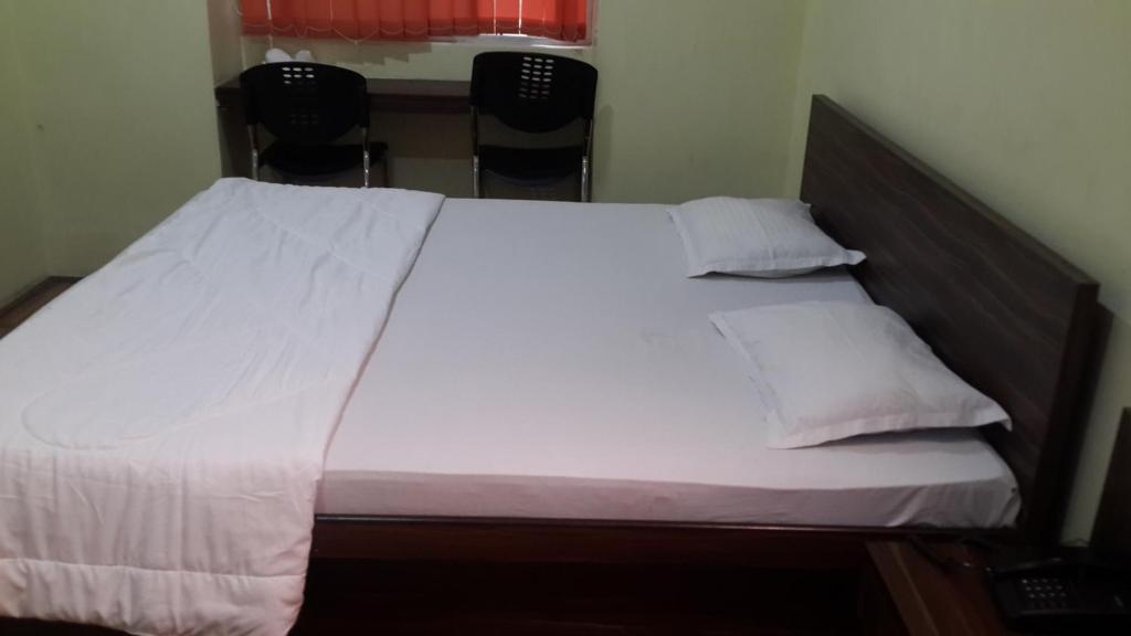 Postel nebo postele na pokoji v ubytování Monovilla Inn
