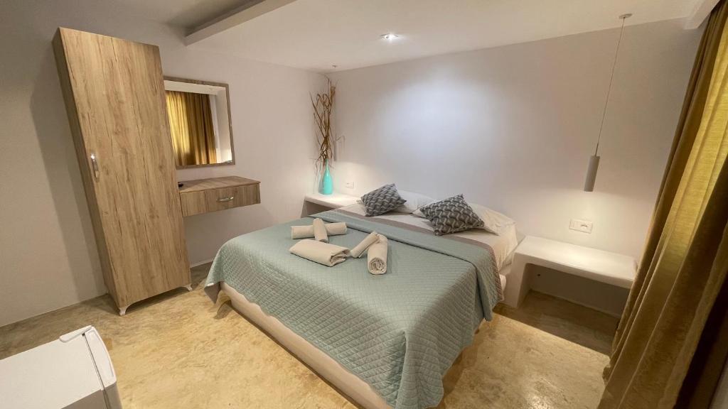 a bedroom with two beds with towels on it at Rida Village Ksamil Island in Ksamil