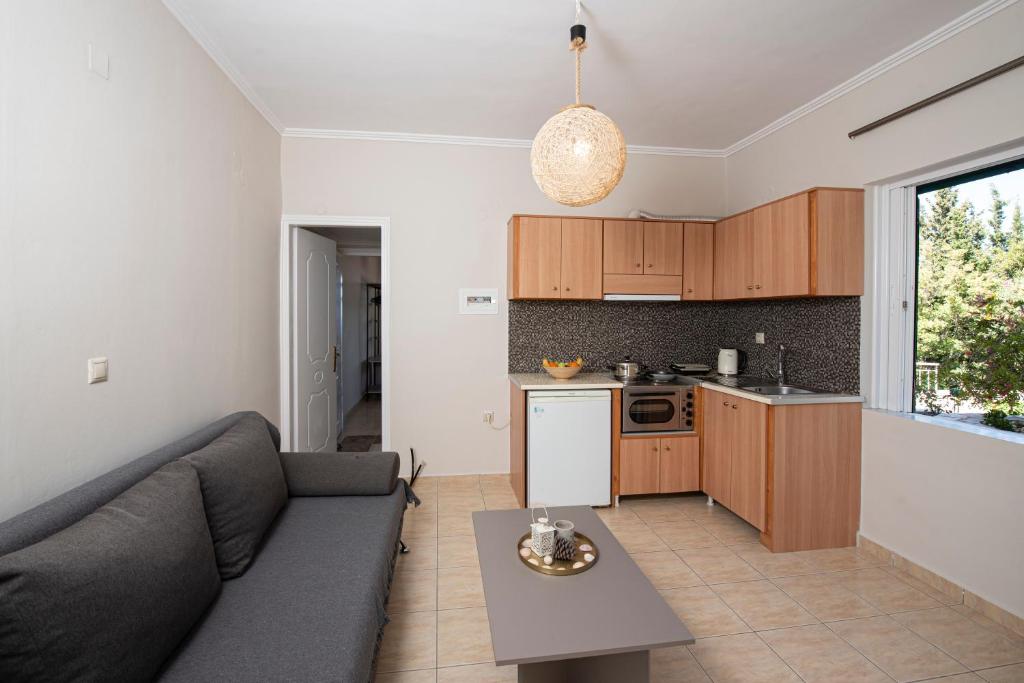 a living room with a couch and a kitchen at Agnantio in Agios Nikitas
