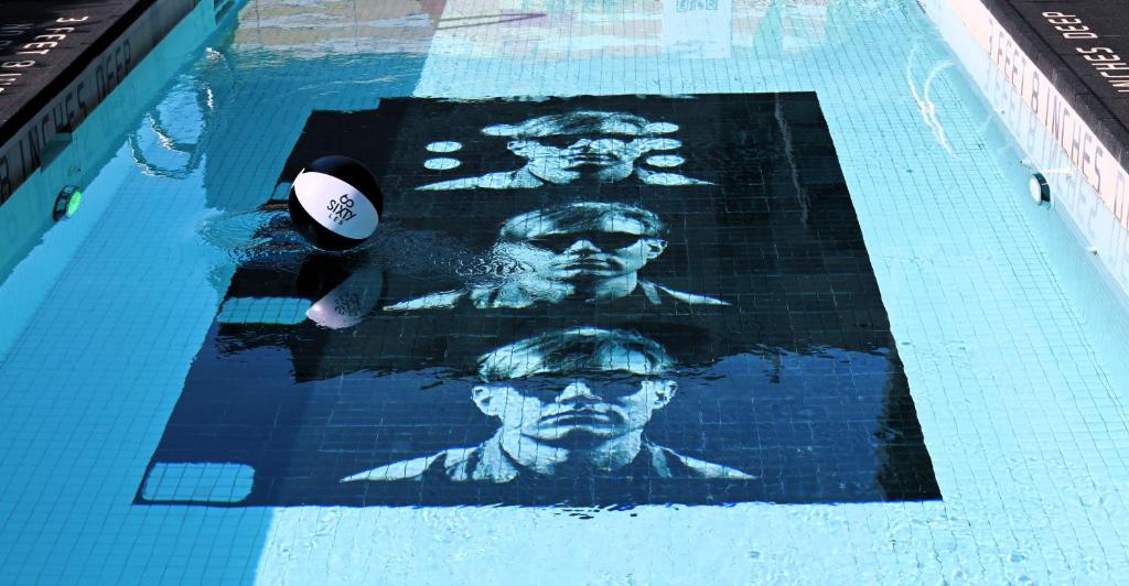 a swimming pool with a picture of two presidents at Sixty LES in New York
