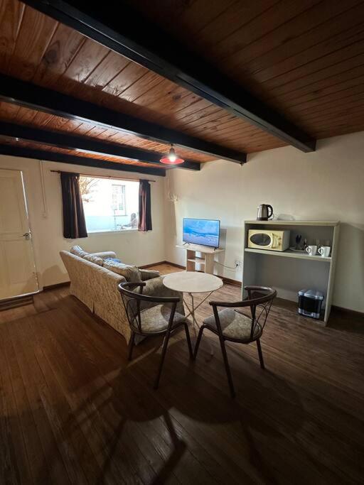a living room with a couch and a table at Central City in San Andrés de Giles