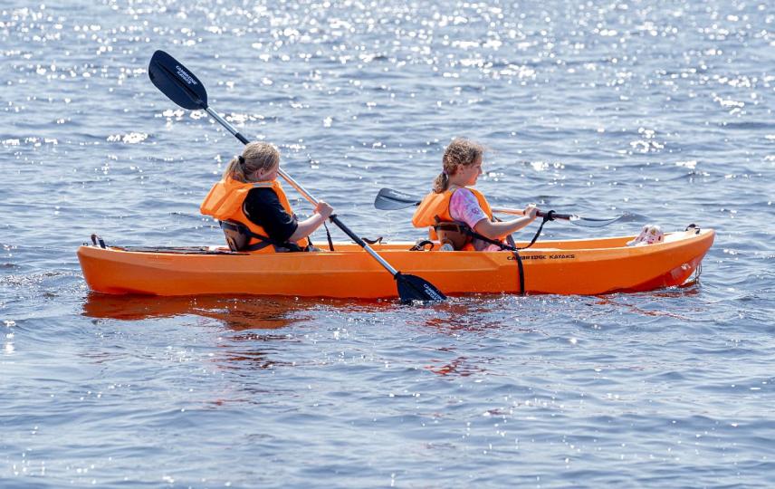 two children are in a kayak in the water at Lochview Retreat Caravan in Balminnoch