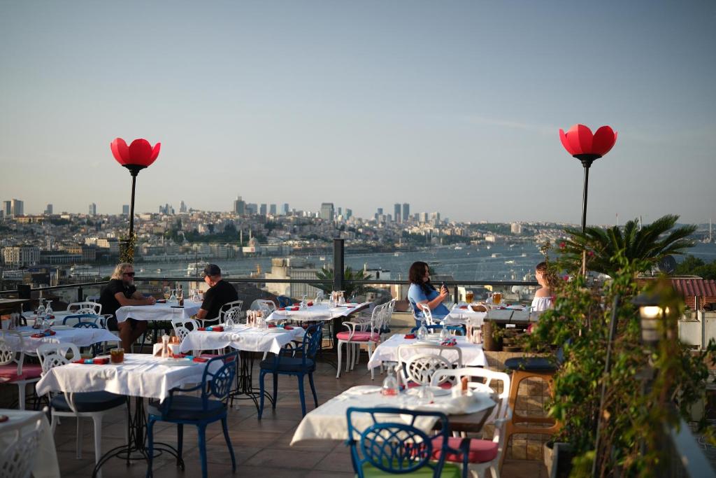 a restaurant with tables and chairs with a view of the city at Raymond Blue Hotel in Istanbul