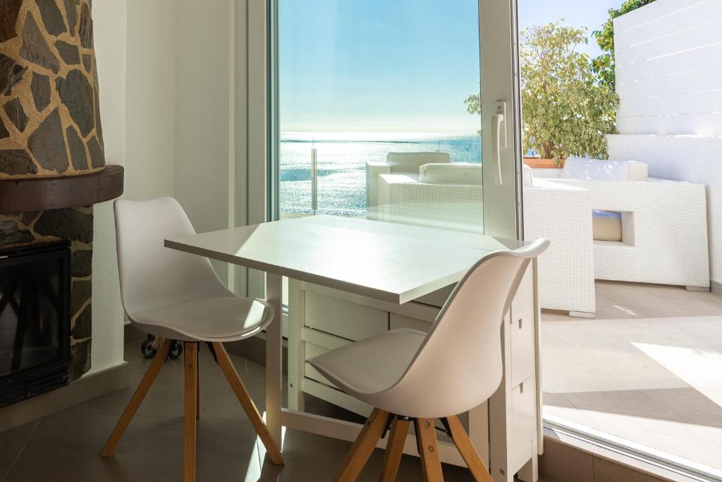 a table and two chairs in a room with a window at Maryvilla Inspiración y Vacaciones - Bungalows in Calpe