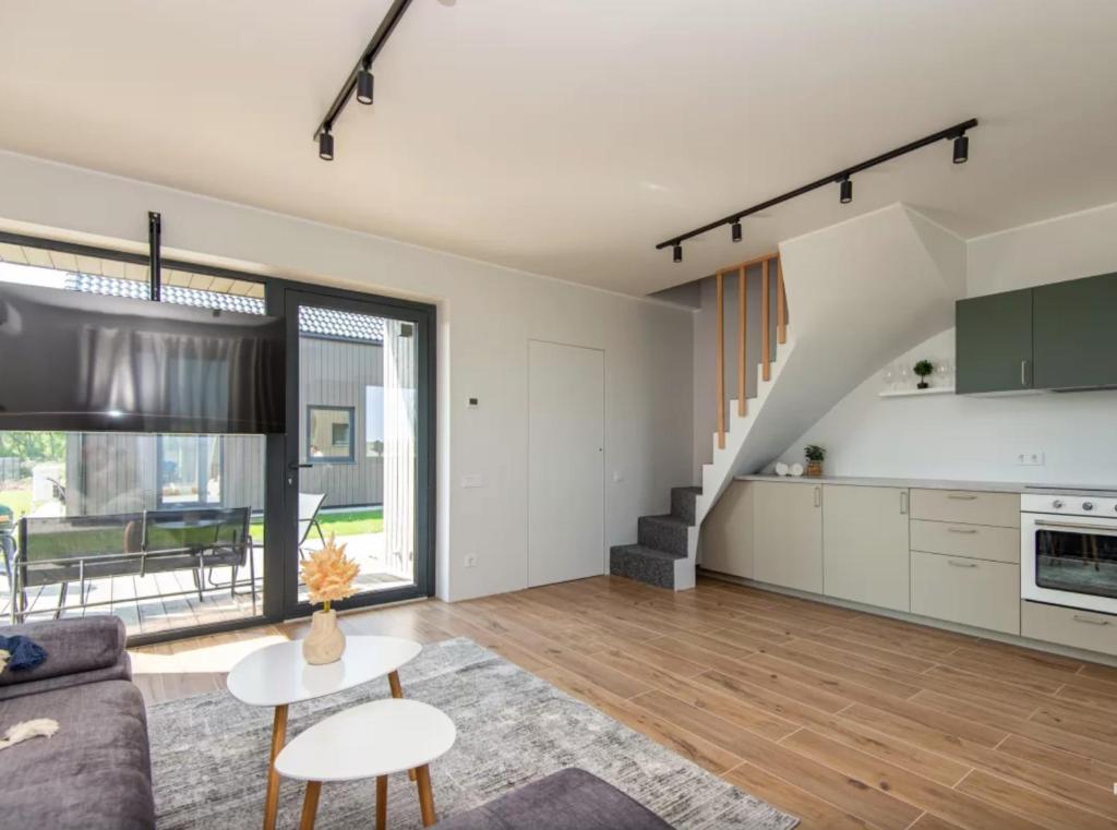 a living room with a couch and a table at Kopų banga in Palanga