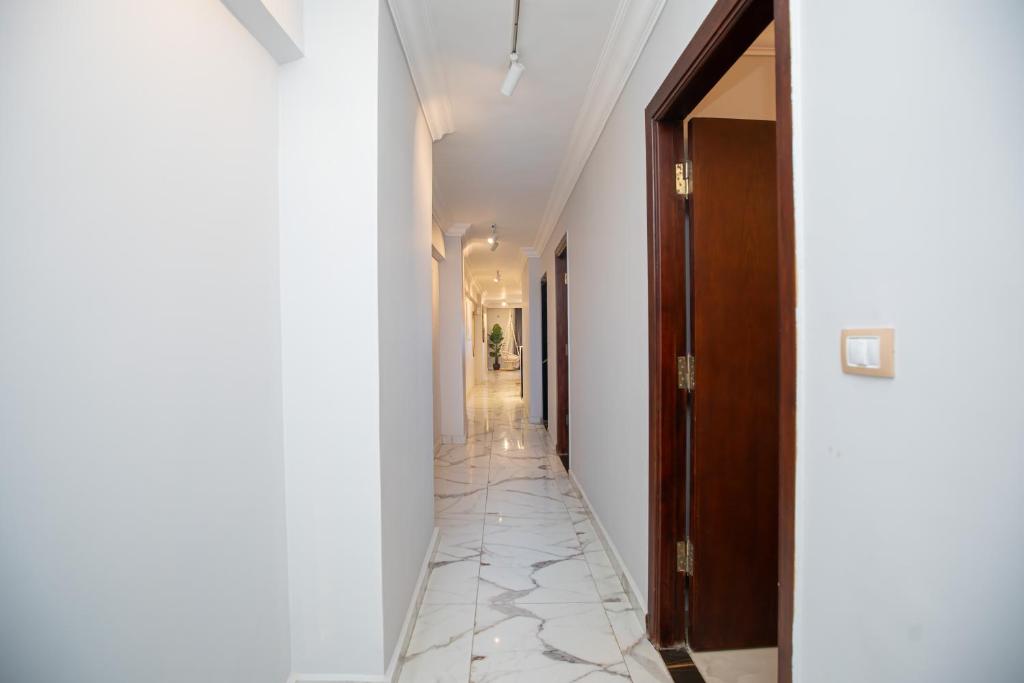 a hallway with white walls and a tile floor at Skyline Premium Properties in Alexandria