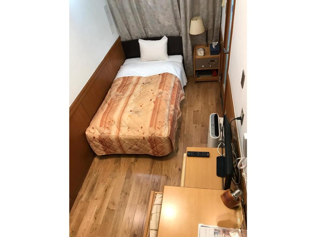 a small room with a bed and boxes in it at Business Hotel Crescent - Vacation STAY 49930v in Tokyo