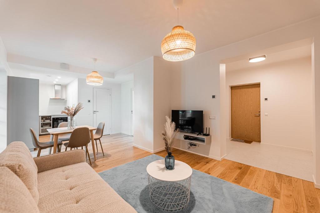 a living room with a couch and a table at Komandandi Apartments in Kuressaare