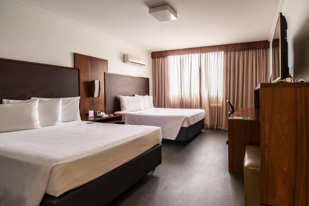 Postel nebo postele na pokoji v ubytování Hotel Deville Business Maringá