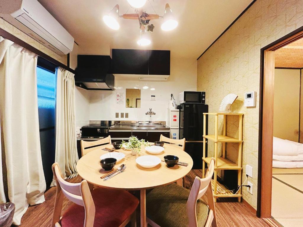 a kitchen and dining room with a table and chairs at Rakuyado II - Vacation STAY 15047v in Kyoto