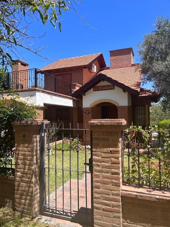 a house with a gate in front of it at El Recuerdo in Merlo