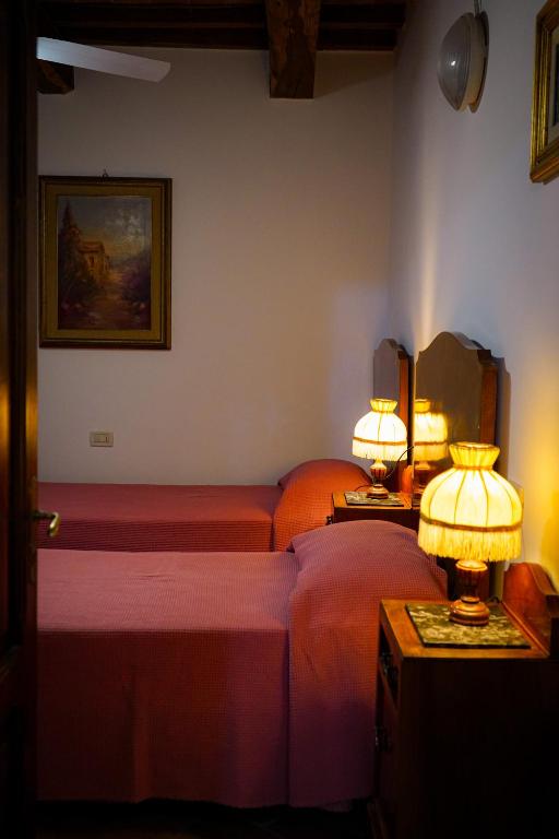 A bed or beds in a room at Le Gorghe di Valmarino