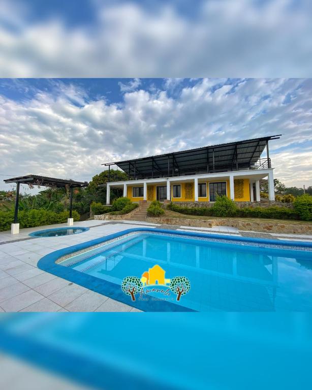 a house with a large swimming pool in front of it at Finca Amarelo casa campestre cap 35 pers in Cali