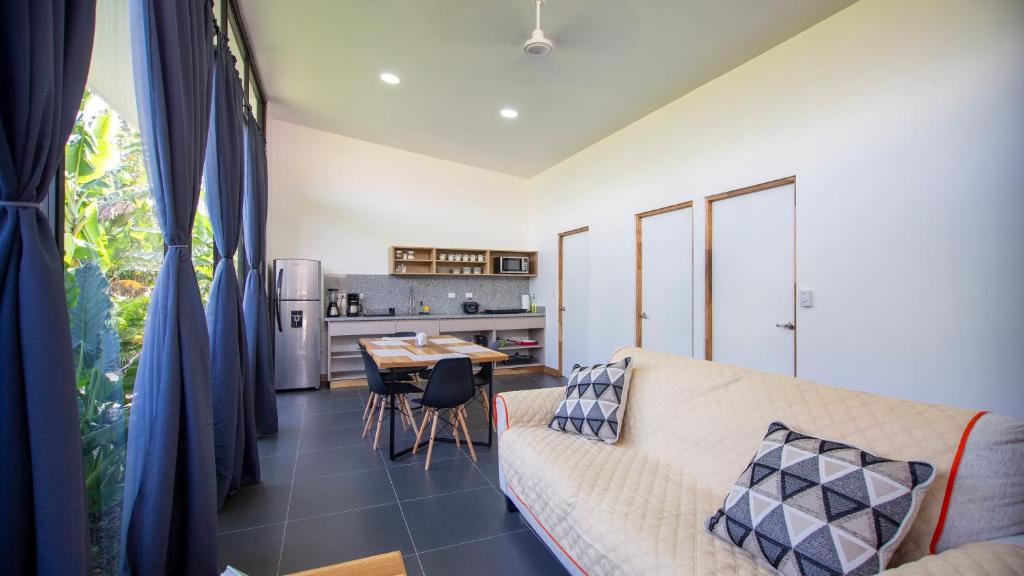 a living room with a couch and a table at Toucan home in Fortuna