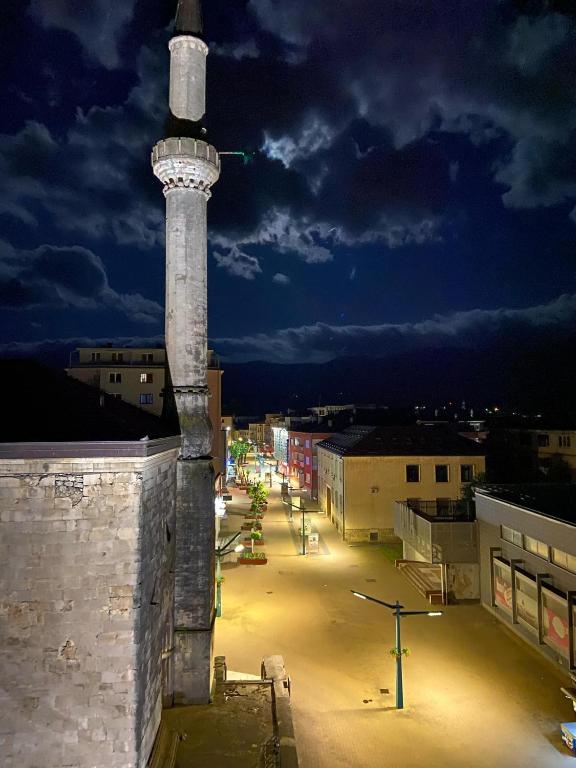a tall tower on top of a building at night at Apartment Center Korzo in Bihać