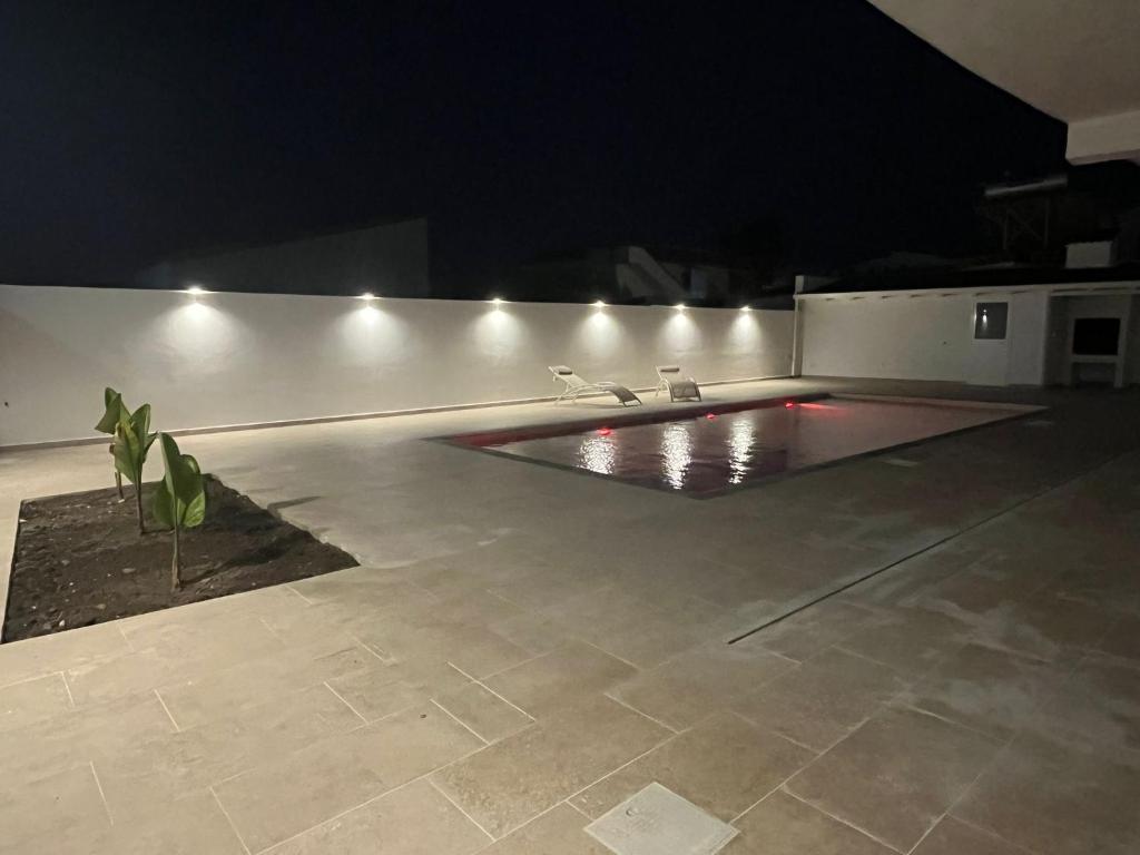 a room with a swimming pool at night at B&B La Dea in Marzamemi