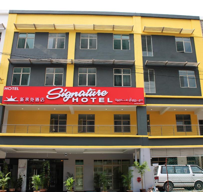 a large building with a red sign on it at Signature Hotel @ Bangsar South in Kuala Lumpur