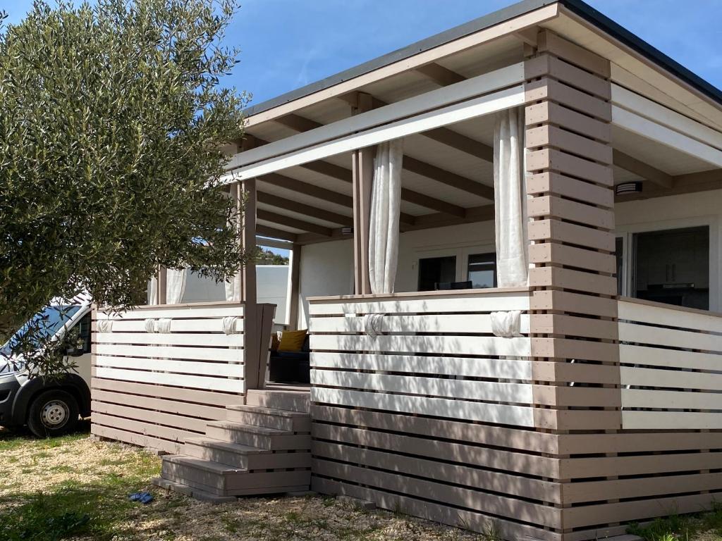 a house with a large window on the side of it at Mediterranean mobile homes - Lotty in Drage