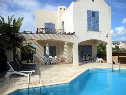 a house with a swimming pool in front of a house at Villa Samantha in Paphos