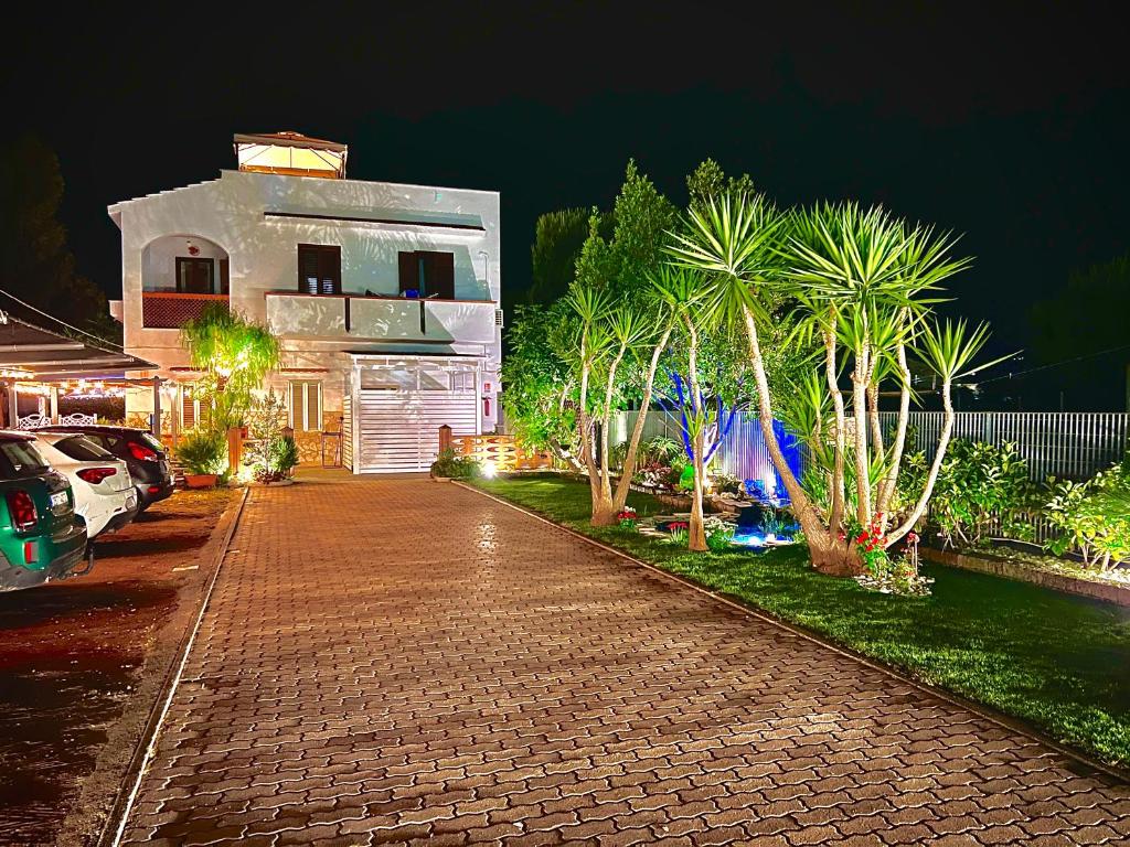 a brick driveway leading to a house at night at Villa Latino in Vieste