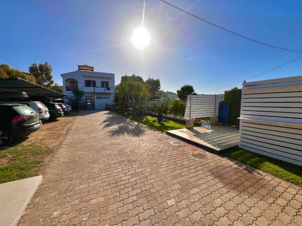 a brick driveway with a building and cars parked at Villa Latino in Vieste
