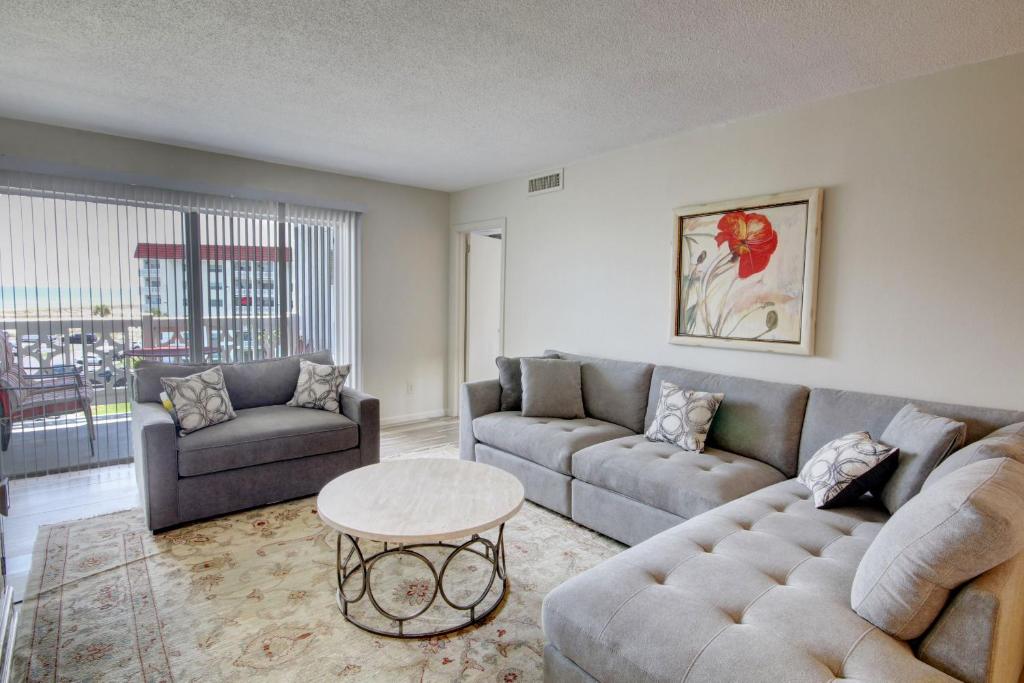 a living room with a couch and a table at El Matador 152 - FREE TICKETS!! Your stay includes free tickets to many area attractions! in Fort Walton Beach