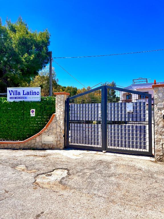a gate in front of a building with a skateboard at Villa Latino in Vieste