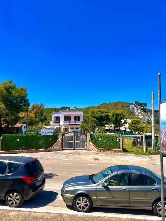 two cars are parked in a parking lot at Villa Latino in Vieste
