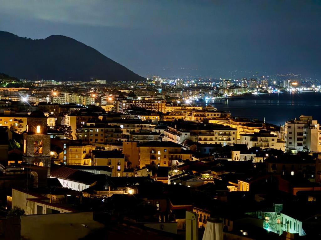 a view of a city at night with lights at Residenza d'Artista al Conservatorio in Salerno