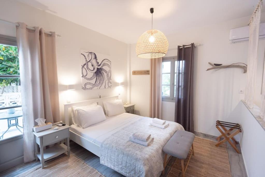 a bedroom with a bed and a desk and a window at SWELL S4 brand new studio in Naousa in Naousa