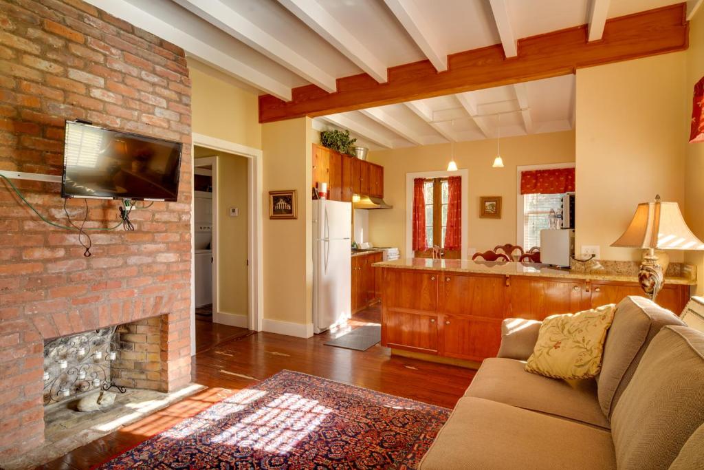 a living room with a couch and a brick fireplace at Tranquil Bayou Country Home with Pond 8 Mi to Houma in Houma