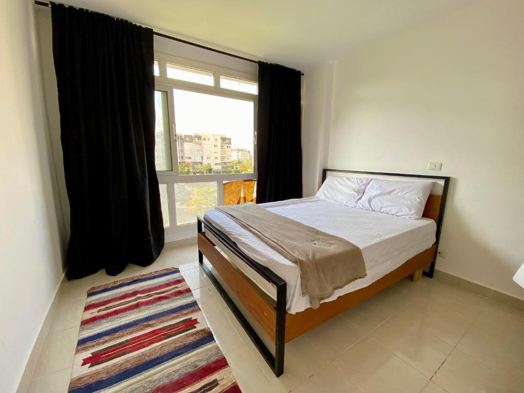 Ένα ή περισσότερα κρεβάτια σε δωμάτιο στο Hotel Home in Madinaty