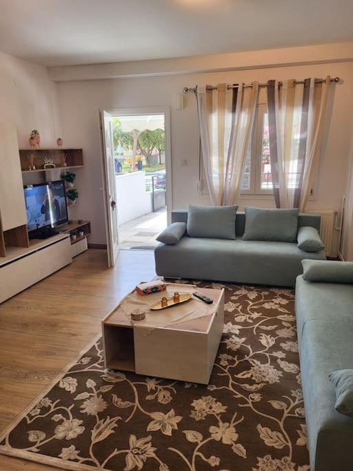 a living room with a couch and a coffee table at Ολοκαίνουρια Iosif's residence in Perea