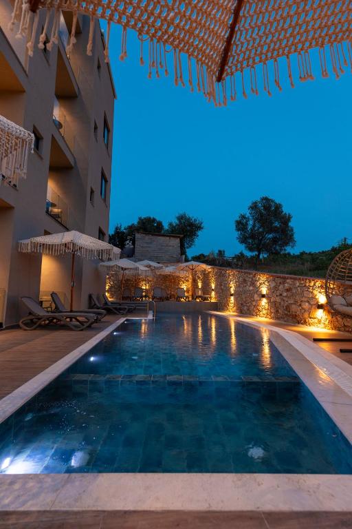 a swimming pool in a hotel at night at Diol Hotel Ksamil in Ksamil