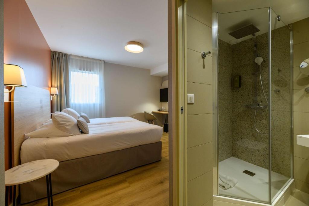 a hotel room with a bed and a shower at Best Western Plus Ajaccio Amirauté in Ajaccio
