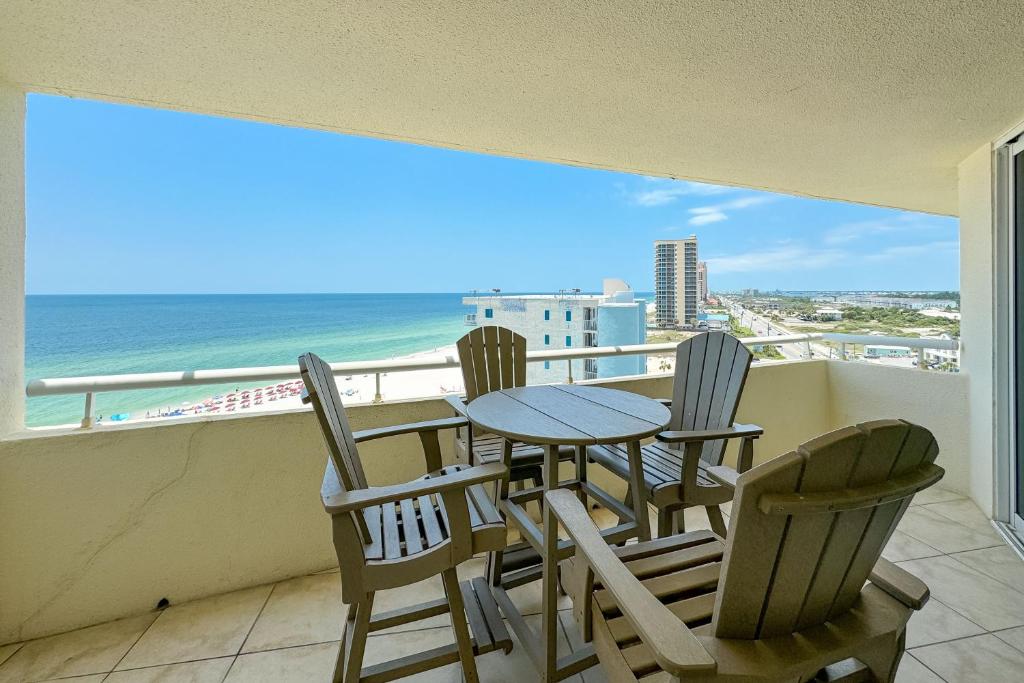 a table and chairs on a balcony with a view of the ocean at Perdido Sun Unit 914 in Pensacola