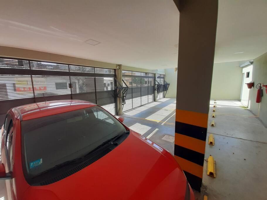 a red car parked in a parking garage at Apart El Carau in Corrientes