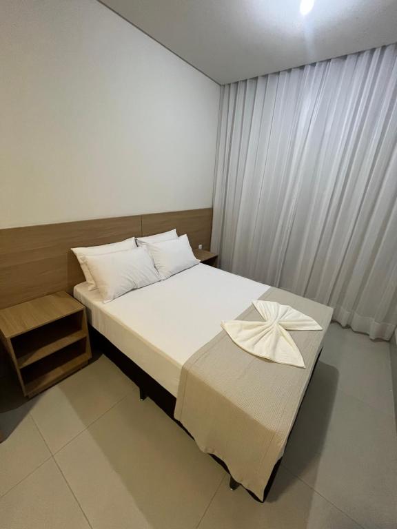 Giường trong phòng chung tại Hotel Premier Janauba