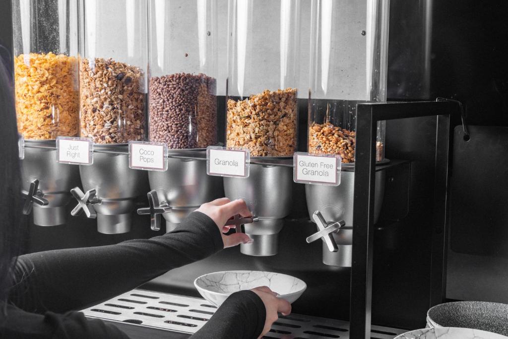 a person is pointing at a display of food at Travelodge Hotel Hurstville Sydney in Sydney