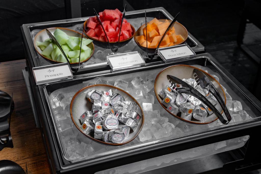 a display of different fruits and vegetables in bowls at Travelodge Hotel Hurstville Sydney in Sydney