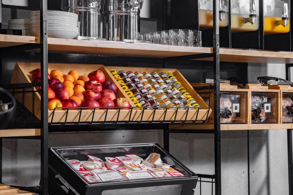 a shelf filled with different types of fruits and snacks at Travelodge Hotel Hurstville Sydney in Sydney