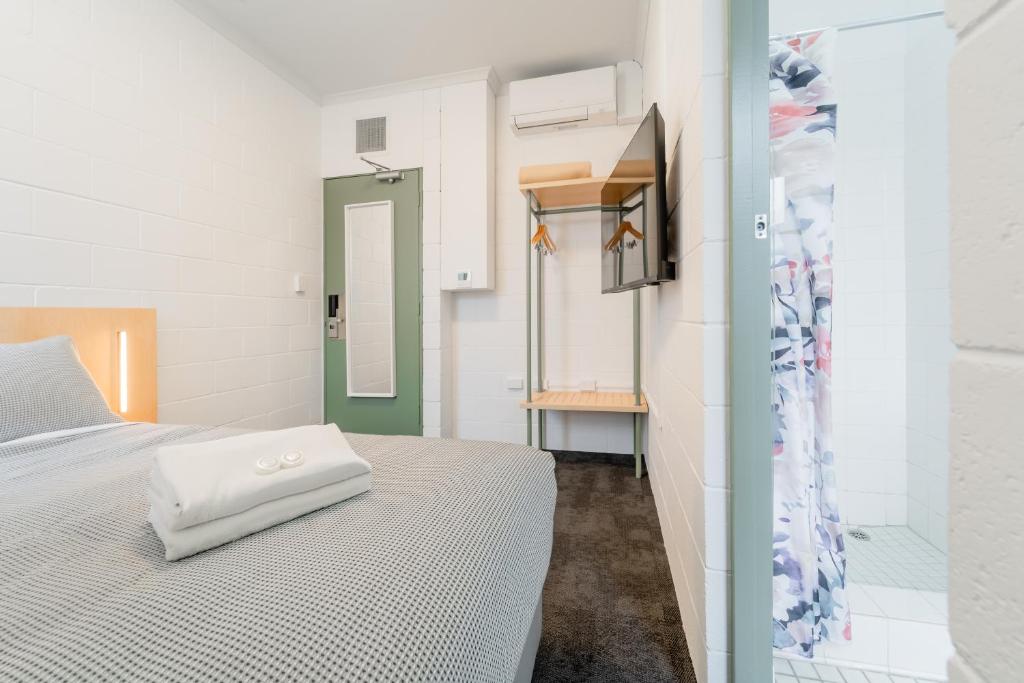 a bed with a white pillow on it in a room at YHA Thredbo in Thredbo