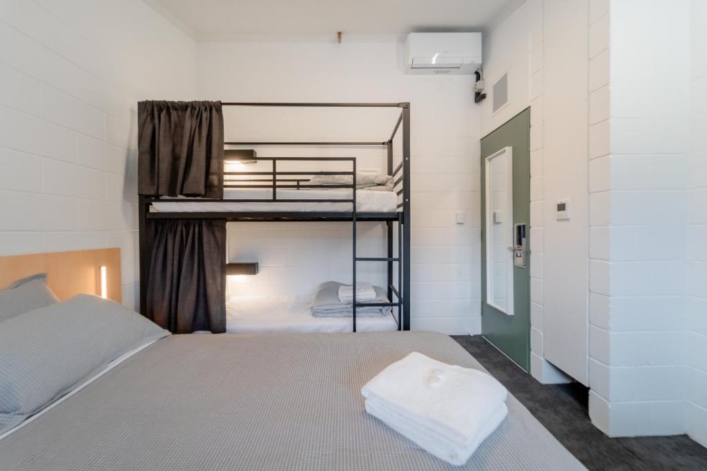 a bedroom with two bunk beds and a window at YHA Thredbo in Thredbo