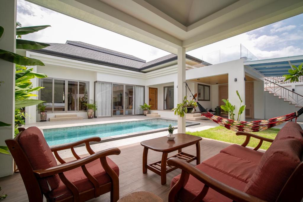 a villa with a swimming pool and a hammock at Villa Anastasia Aonang in Ao Nang 